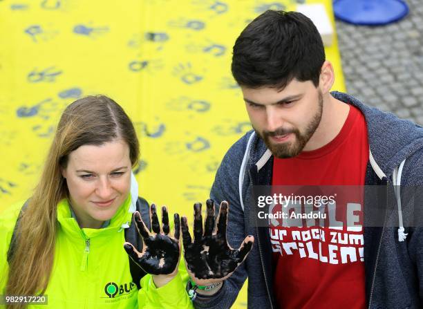 Demonstrators gather to protest against coal-based energy in front of the Chancellery in the 'Stop Coal' protest event on June 24, 2018 in Berlin,...