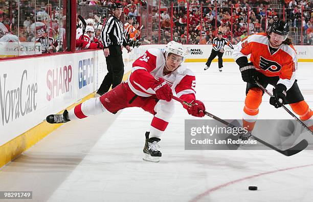 Jonathan Ericsson of the Detroit Red Wings passes the puck past Scott Hartnell of the Philadelphia Flyers on April 4, 2010 at the Wachovia Center in...