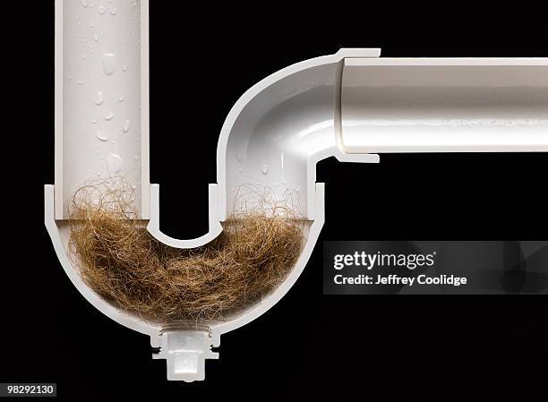 hair ball clog in drain pipe - plugging in stockfoto's en -beelden