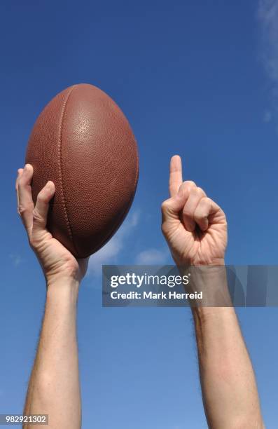 american football player celebrates a touchdown - touchdown letters stock pictures, royalty-free photos & images