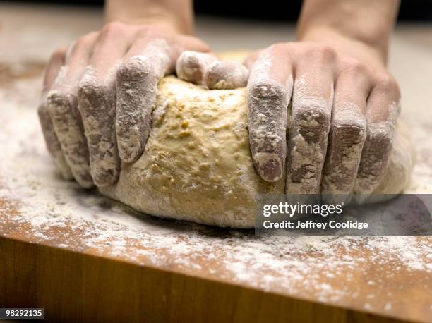 woman kneading bread dough, close-up of hands - jeffrey coolidge stock-fotos und bilder