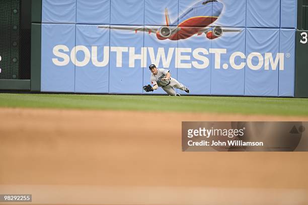 Left fielder Travis Snider of the Toronto Blue Jays fields his position as he dives to make the catch of a sinking line drive during the game against...