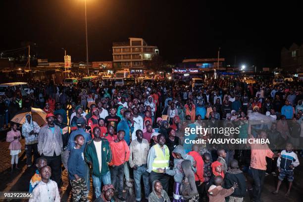 People in Kenya watch the Russia 2018 World Cup Group H football match between Japan and Senegal on a giant display near a sports betting company in...