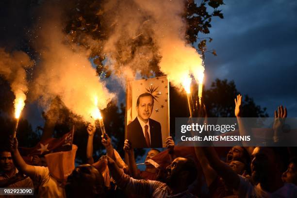 People react outside the Justice and Development Party headquarters in Istanbul, on June 24 during the Turkish presidential and parliamentary...