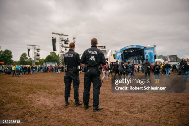 Two police officers patrol during the third day of the Hurricane festival on June 24, 2018 in Scheessel, Germany.