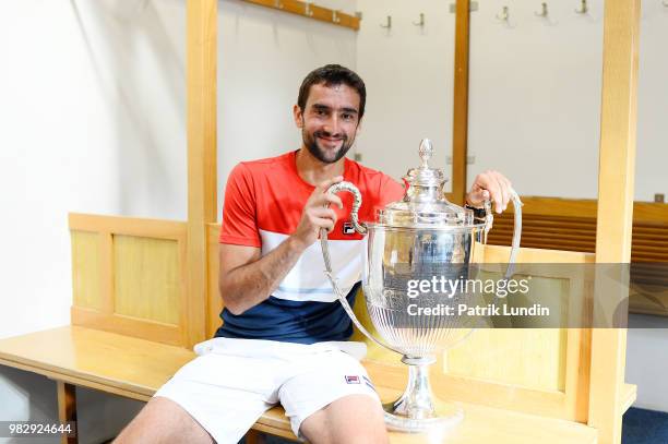 Marin Cilic of Croatia with the trophy after victory in the final match against Novak Djokovic of Serbia during Day seven of the Fever-Tree...