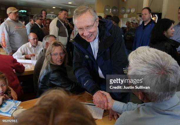 Senate Majority Leader Harry Reid greets patrons at T.J.'s Pizza Shack April 6, 2010 in Fernley, Nevada. Sen. Reid continues his three day bus tour...