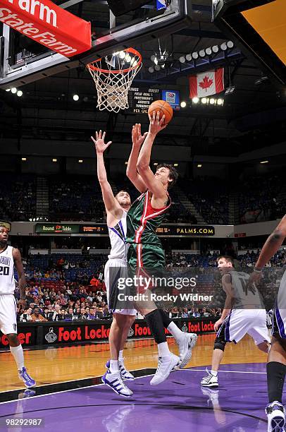 Andrew Bogut of the Milwaukee Bucks shoots a layup against Spencer Hawes of the Sacramento Kings during the game at Arco Arena on March 19, 2010 in...