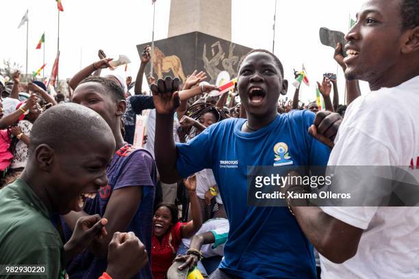 Senegal fans watch game two of group H of the World Cup match between Japan and Senegal at Obelisque square on June 24, 2018 in Dakar, Senegal. The...