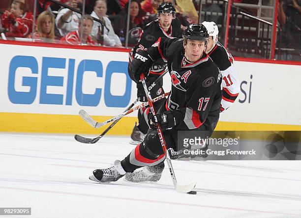 Rod Brind'Amour of the Carolina Hurricanes scoops up a loose puck during a NHL game against the New Jersey Devils on April 3, 2010 at RBC Center in...