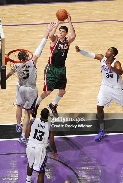 Ersan Ilyasova of the Milwaukee Bucks shoots a jumper against Andres Nocioni, Tyreke Evans and Jason Thompson of the Sacramento Kings during the game...