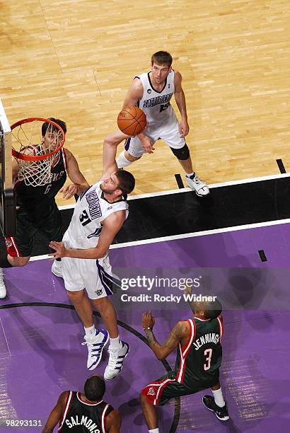 Spencer Hawes of the Sacramento Kings dunks against Andrew Bogut, John Salmons and Brandon Jennings of the Milwaukee Bucks during the game at Arco...