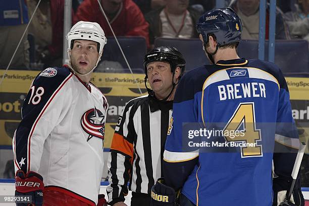 Referee Dan O'Halloran explains a penalty call to R.J. Umberger of the Columbus Blue Jackets and Eric Brewer of the St. Louis Blues on April 5, 2010...