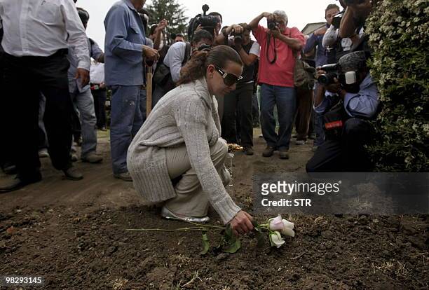 Lissette Farah, the mother of Paulette Gebara, lays a flower during her daughter's funeral at the France Cemetery, in Mexico City, on April 6, 2010....