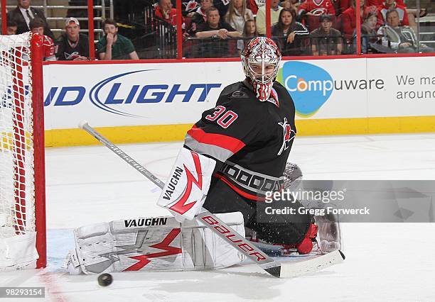 Cam Ward of the Carolina Hurricanes makes a save and deflects the puck during a NHL game against the New Jersey Devils on April 3, 2010 at RBC Center...
