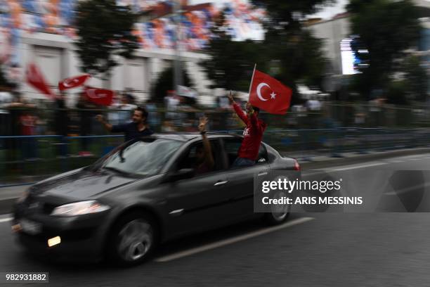 People react outside the Justice and Development Party headquarters in Istanbul, on June 24 during the Turkish presidential and parliamentary...