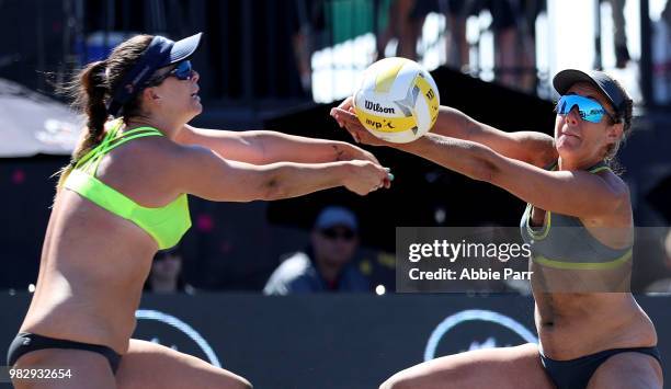 Caitlin Ledoux and April Ross reach for the ball against Kelly Claes and Brittany Hichevar during the final rounds of the AVP Seattle Open at Lake...