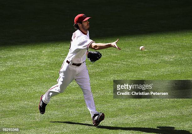 Starting pitcher Dan Haren of the Arizona Diamondbacks flips the ball to first base for an out against the San Diego Padres during the Opening Day...