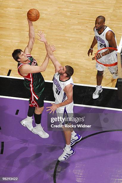 Andrew Bogut of the Milwaukee Bucks goes up for a shot against Spencer Hawes of the Sacramento Kings during the game at Arco Arena on March 19, 2010...