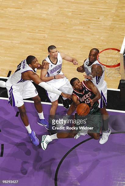 John Salmons of the Milwaukee Bucks goes up for a shot against Jason Thompson, Francisco Garcia and Carl Landry of the Sacramento Kings during the...