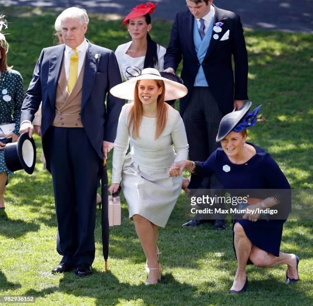 Prince Andrew, Duke of York doffs his top hat whilst Princess Beatrice and Sarah, Duchess of York curtsy to Queen Elizabeth II as she and her guests...