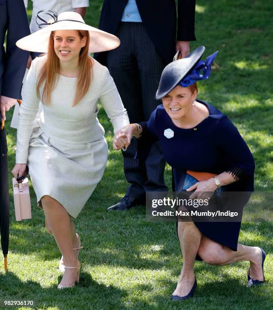 Princess Beatrice and Sarah, Duchess of York curtsy to Queen Elizabeth II as she and her guests pass by in horse drawn carriages on day 4 of Royal...