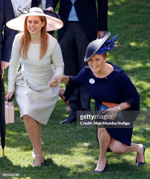 Princess Beatrice and Sarah, Duchess of York curtsy to Queen Elizabeth II as she and her guests pass by in horse drawn carriages on day 4 of Royal...