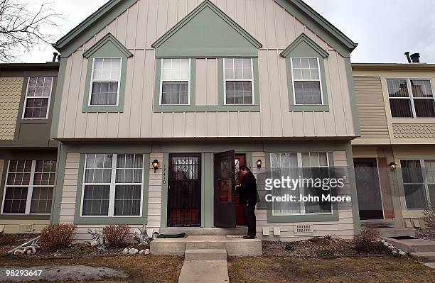 Arapahoe County sheriff's deputy Jim Osborn knocks on an apartment door to announce an eviction on April 6, 2010 in Aurora, Colorado. A family had...