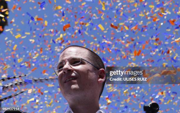 Mexico's presidential candidate Ricardo Anaya, standing for the "Mexico al Frente" coalition of the PAN-PRD-Movimiento Ciudadano parties, looks on...