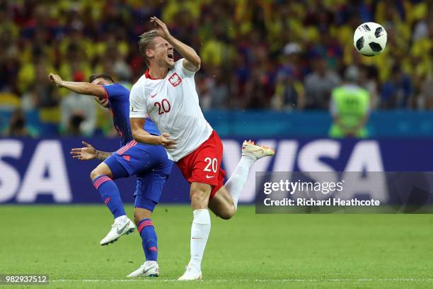 Juan Quintero of Colombia collides with Lukasz Piszczek of Poland during the 2018 FIFA World Cup Russia group H match between Poland and Colombia at...