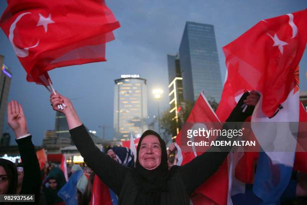 Party supporters wave flags in front of the AKP headquarters in Ankara on June 24, 2018. Turkish President was on June 24, 2018 leading a...