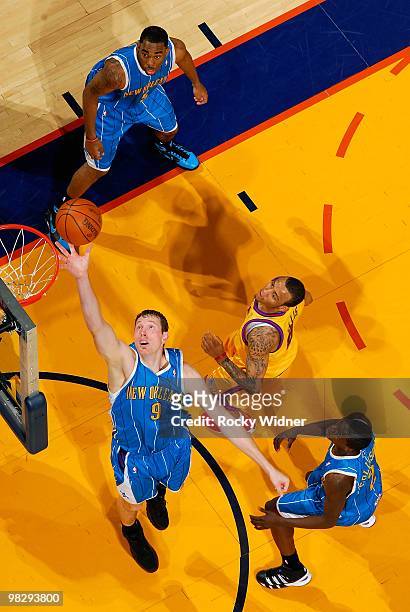 Darius Songaila of the New Orleans Hornets reaches for a rebound against the Golden State Warriors on March 17, 2009 at Oracle Arena in Oakland,...