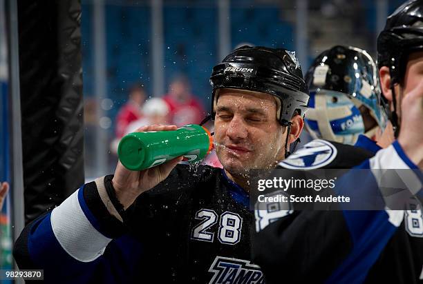 Zenon Konopka of the Tampa Bay Lightning cools off with a drink during pre-game skate against the Carolina Hurricanes at the St. Pete Times Forum on...