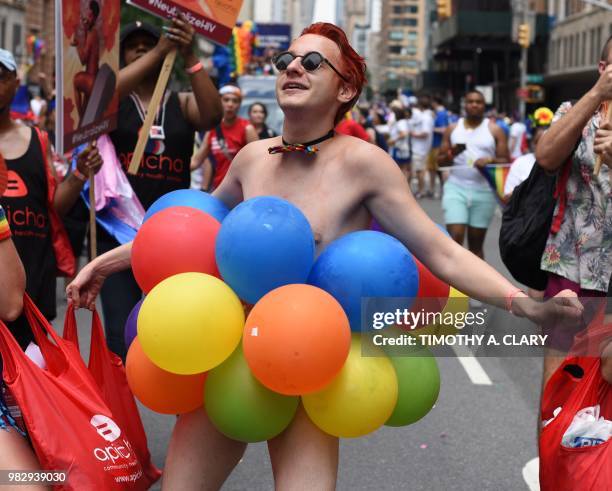 People take part in the annual 2018 New York City Pride Parade on June 24, 2018 as they make their way down 7th Avenue in New York.