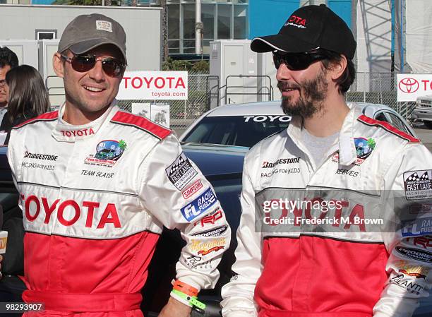 Actors Christian Slater and Keanu Reeves pose for photographers during the press practice day for the Toyota Pro/Celebrity Race on April 6, 2010 in...