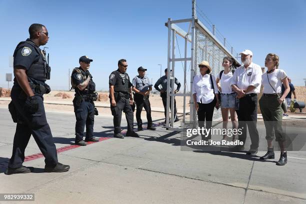 Filmmaker Rob Reiner his wife Michele Reiner and their daughter Romy Reiner speak with Department of Homeland Security police officers near the tent...