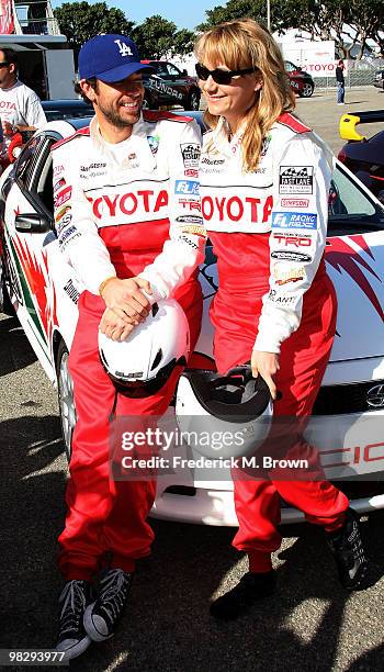 Actor Zachary Levi and actress Megyn Price pose for photographers during the press practice day for the Toyota Pro/Celebrity Race on April 6, 2010 in...