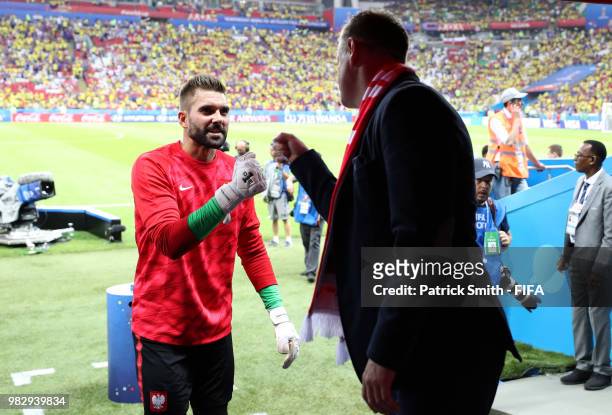 Bartosz Bialkowski of Poland greets former Poland player Jacek Krzynowek prior to the 2018 FIFA World Cup Russia group H match between Poland and...