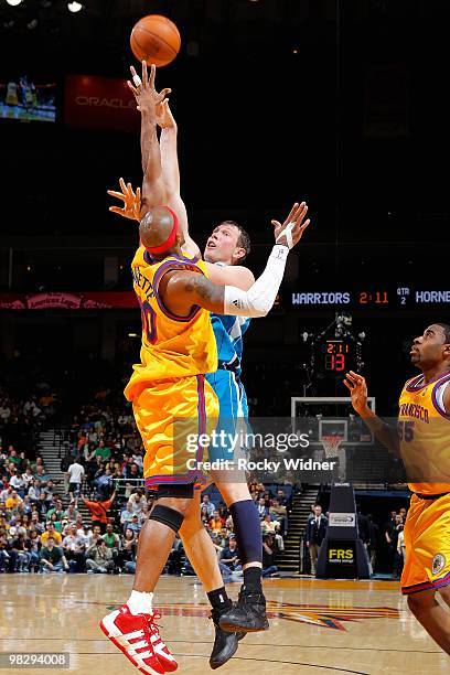 Darius Songaila of the New Orleans Hornets shoots over Corey Maggette of the Golden State Warriors during the game on March 17, 2009 at Oracle Arena...