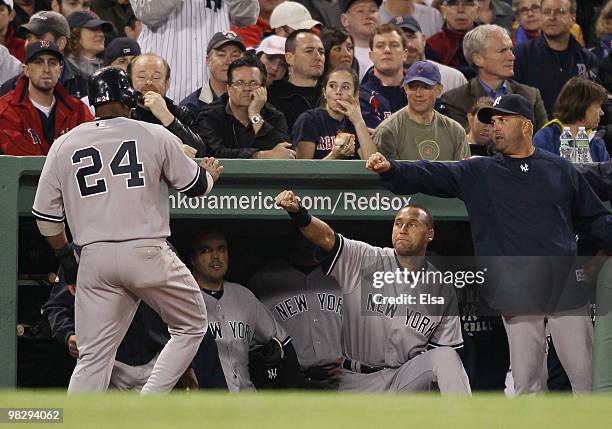 Robinson Cano of the New York Yankees is congratulated by teammate Derek Jeter after Cano scored in the second inning against Boston Red Sox on April...