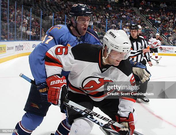 Andy Greene of the New Jersey Devils battles for the puck against Rich Peverley of the Atlanta Thrashers at Philips Arena on April 6, 2010 in...