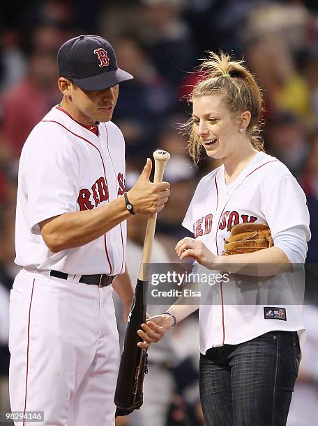 Olympic gold medalist Hannah Kearney talks with Jacoby Ellsbury of the Boston Red Sox after she threw out the ceremonial first pitch before the game...