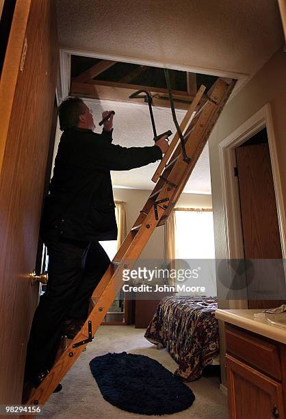 Arapahoe County sheriff's deputy Jim Osborn, his weapon drawn, searches an apartment while supervising an eviction on April 6, 2010 in Aurora,...