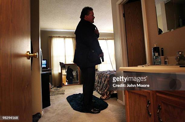 Arapahoe County sheriff's deputy Jim Osborn, his weapon drawn, searches an apartment before supervising an eviction on April 6, 2010 in Aurora,...