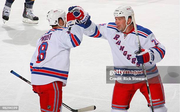 Brandon Prust and Anders Eriksson of the New York Rangers celebrate Prust's goal aginst the Buffalo Sabres in the first period at HSBC Arena on April...