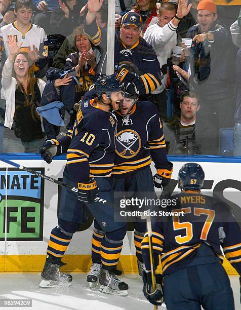 Henrik Tallinder, Drew Stafford and Tyler Myers of the Buffalo Sabres celebrate Stafford's goal against the New York Rangers at HSBC Arena on April...