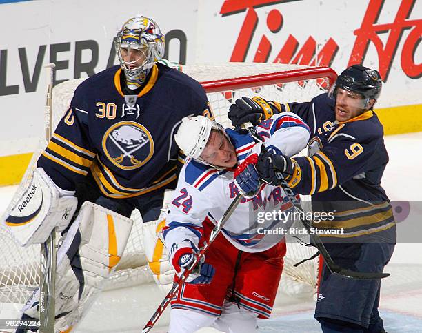 Ryan Callahan of the New York Rangers is cross-checked in front of Ryan Miller of the Buffalo Sabres by Derek Roy at HSBC Arena on April 6, 2010 in...