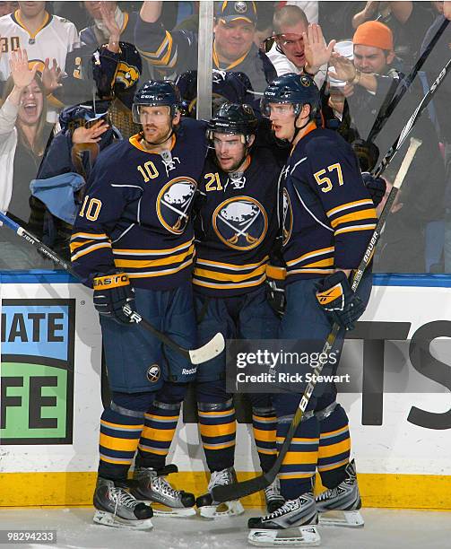 Henrik Tallinder, Drew Stafford and Tyler Myers of the Buffalo Sabres celebrate Stafford's goal against the New York Rangers at HSBC Arena on April...