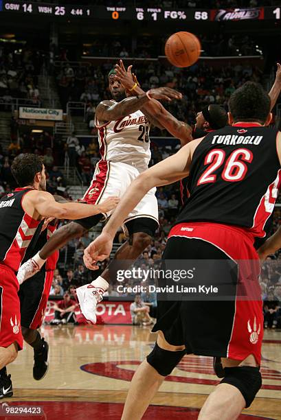 LeBron James of the Cleveland Cavaliers no look passes while surrounded by four Toronto Raptors players on April 6, 2010 at The Quicken Loans Arena...