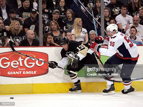 Bill Guerin of the Pittsburgh Penguins battle for a loose puck with Jeff Schultz of the Washington Capitals in the first period at Mellon Arena on...